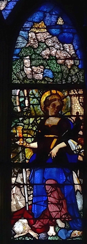 sainte Catherine tenant le glaive qui a servi à la décapiter. Un homme est sous ses pieds